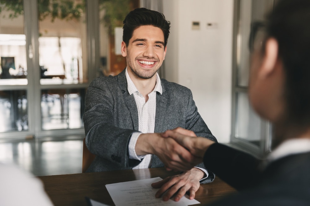 Kunskapsbanken Business Career Placement Concept Happy Caucasian Man 30s Rejoicing Shaking Hands With Employee When Was Recruited During Interview Office 1 - GMAT vs. GRE: Choosing the Right Test for Your MBA Application - Ameerkhatri.com - MBA Blog - mba gmat vs gre - GMAT vs. GRE